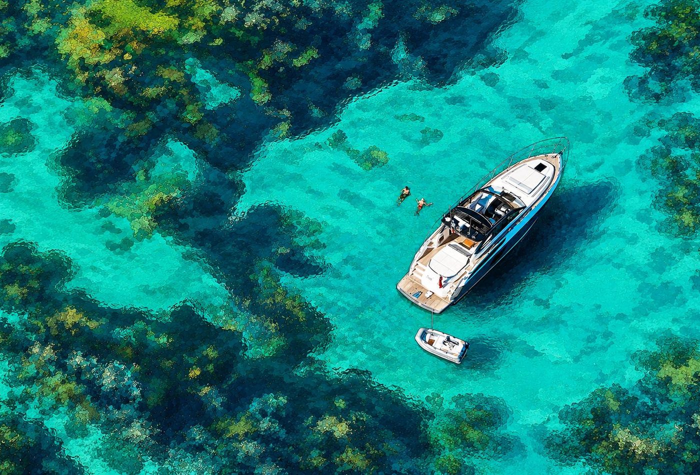 Aerial view of a motor yacht anchored over a turquoise Indonesian coral reef